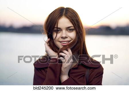 Portrait of smiling Caucasian woman at waterfront View Large Photo Image Stock Image - Portrait of smiling Caucasian woman at waterfront. Fotosearch