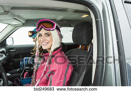 Portrait of smiling Caucasian woman in car in winter View Large Photo Image Stock Image - Portrait of smiling Caucasian woman in car in winter. Fotosearch