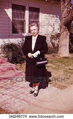 Portrait of smiling Caucasian woman standing near front stoop View Large Photo Image Picture - Portrait of smiling Caucasian woman standing near front stoop. Fotosearch