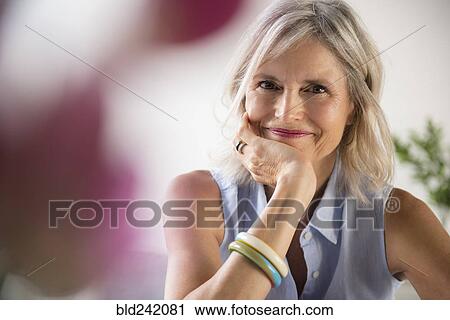 Portrait of smiling Caucasian woman resting hand on chin View Large Photo Image Stock Image - Portrait of smiling Caucasian woman resting hand on chin. Fotosearch