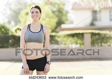 Stock Image - Portrait of smiling Caucasian woman runner. Fotosearch