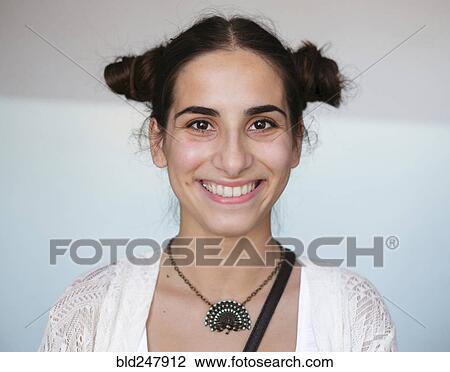 Stock Image - Portrait of smiling Caucasian woman wearing necklace. Fotosearch