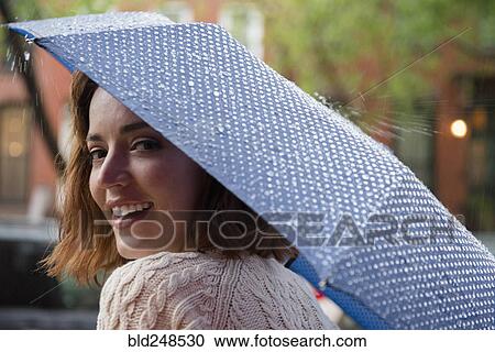 Portrait of smiling Caucasian woman holding umbrella View Large Photo Image Stock Image - Portrait of smiling Caucasian woman holding umbrella. Fotosearch