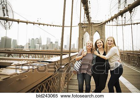 Stock Photography - Portrait of smiling Caucasian women posing on bridge. Fotosearch