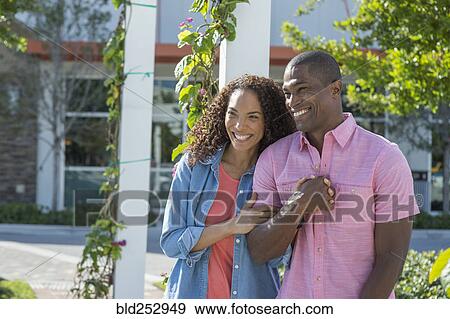 Portrait of smiling couple holding hands and laughing View Large Photo Image Stock Photo - Portrait of smiling couple holding hands and laughing. Fotosearch