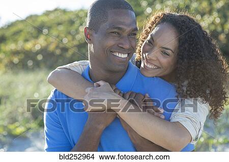 Picture - Portrait of smiling couple hugging. Fotosearch