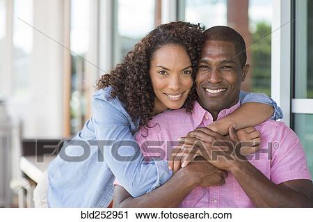 Portrait of smiling couple hugging View Large Photo Image Stock Image - Portrait of smiling couple hugging. Fotosearch
