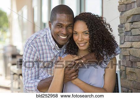 Portrait of smiling couple hugging View Large Photo Image Stock Photo - Portrait of smiling couple hugging. Fotosearch