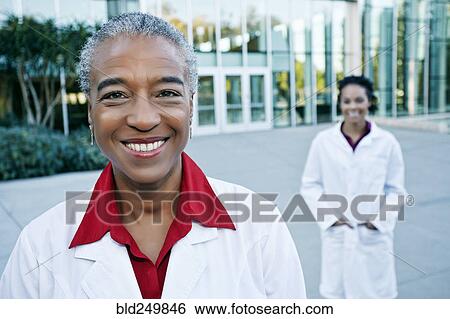 Portrait of smiling doctor outdoors at hospital View Large Photo Image Stock Photograph - Portrait of smiling doctor outdoors at hospital. Fotosearch