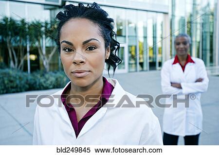 Stock Photography - Portrait of smiling doctor outdoors at hospital. Fotosearch
