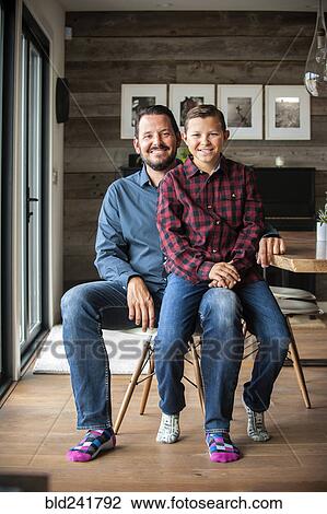 Stock Image - Portrait of smiling father and son. Fotosearch