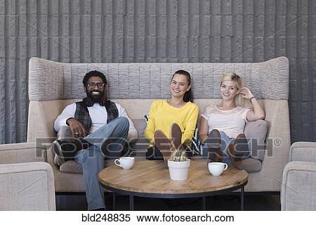 Portrait of smiling friends in lounge View Large Photo Image Stock Photography - Portrait of smiling friends in lounge. Fotosearch