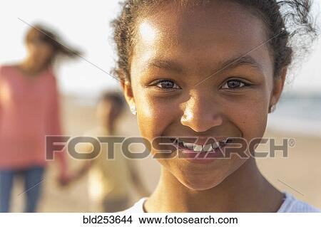 Portrait of smiling girl at beach View Large Photo Image Picture - Portrait of smiling girl at beach. Fotosearch