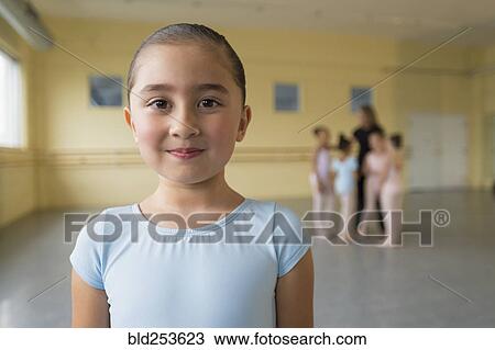 Stock Image - Portrait of smiling girl in ballet studio. Fotosearch