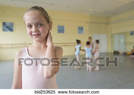 Stock Photography - Portrait of smiling girl in ballet studio. Fotosearch