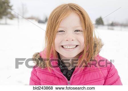 Stock Photo - Portrait of smiling girl in winter. Fotosearch