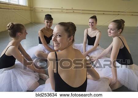 Portrait of smiling girl sitting on floor in ballet studio View Large Photo Image Picture - Portrait of smiling girl sitting on floor in ballet studio. Fotosearch