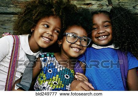 Portrait of smiling girls near wooden wall View Large Photo Image Stock Photo - Portrait of smiling girls near wooden wall. Fotosearch