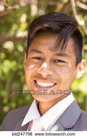 Stock Photo - Portrait of smiling Hispanic boy wearing suit. Fotosearch
