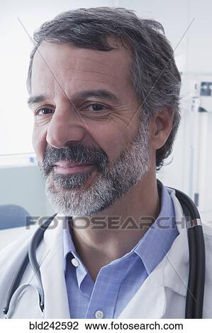 Stock Image - Portrait of smiling Hispanic doctor. Fotosearch