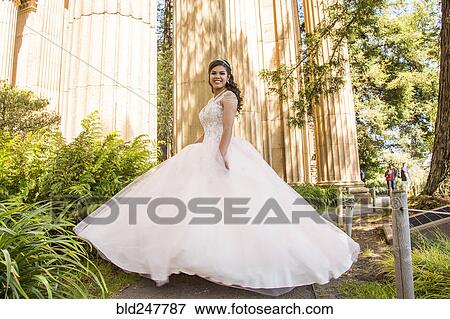 Portrait of smiling Hispanic girl wearing gown View Large Photo Image Stock Photo - Portrait of smiling Hispanic girl wearing gown. Fotosearch