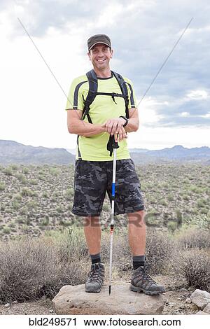 Portrait of smiling Hispanic man hiking in desert View Large Photo Image Stock Image - Portrait of smiling Hispanic man hiking in desert. Fotosearch