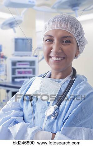 Stock Image - Portrait of smiling Hispanic surgeon. Fotosearch