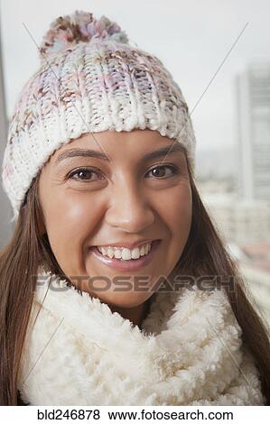 Portrait of smiling Hispanic woman wearing hat and scarf View Large Photo Image Stock Photo - Portrait of smiling Hispanic woman wearing hat and scarf. Fotosearch