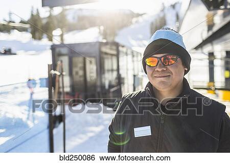 Stock Photograph - Portrait of smiling man outdoors in snow. Fotosearch