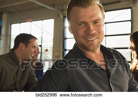 Portrait of smiling man with friends View Large Photo Image Stock Photograph - Portrait of smiling man with friends. Fotosearch