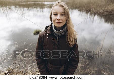 Portrait of smiling Middle Eastern woman near pond View Large Photo Image Picture - Portrait of smiling Middle Eastern woman near pond. Fotosearch