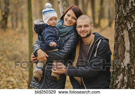 Portrait of smiling Middle Eastern couple and baby son near tree View Large Photo Image Stock Photo - Portrait of smiling Middle Eastern couple and baby son near tree. Fotosearch