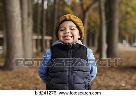 Portrait of smiling Mixed Race boy in park View Large Photo Image Stock Photograph - Portrait of smiling Mixed Race boy in park. Fotosearch