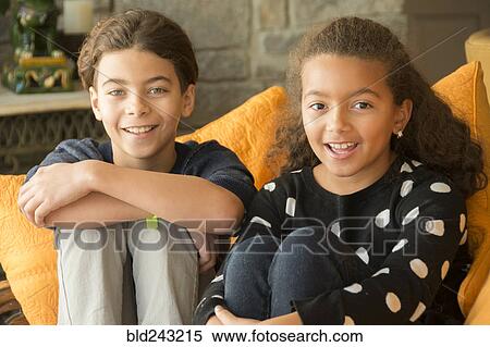 Stock Photography - Portrait of smiling Mixed Race brother and sister. Fotosearch