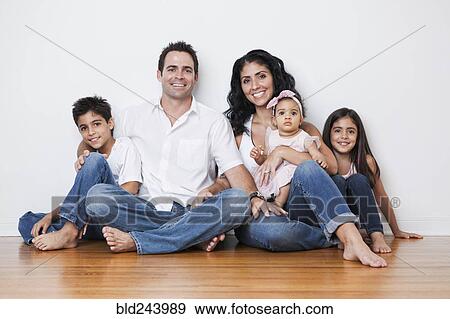 Portrait of smiling Mixed Race family sitting on floor View Large Photo Image Stock Photo - Portrait of smiling Mixed Race family sitting on floor. Fotosearch