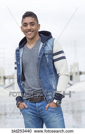 Stock Image - Portrait of smiling Mixed Race man. Fotosearch