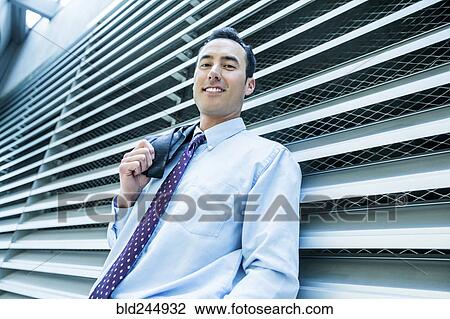 Portrait of smiling Mixed Race businessman leaning on wall View Large Photo Image Stock Image - Portrait of smiling Mixed Race businessman leaning on wall. Fotosearch