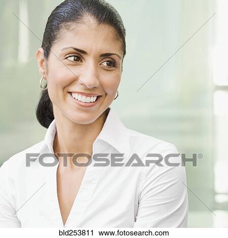 Stock Image - Portrait of smiling Mixed Race businesswoman. Fotosearch