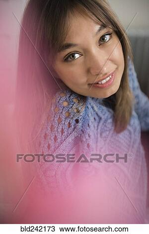 Stock Image - Portrait of smiling Mixed Race woman. Fotosearch