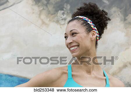 Portrait of smiling Mixed Race woman near wall View Large Photo Image Stock Photo - Portrait of smiling Mixed Race woman near wall. Fotosearch