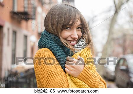 Portrait of smiling Mixed Race woman wearing scarf in city View Large Photo Image Stock Photograph - Portrait of smiling Mixed Race woman wearing scarf in city. Fotosearch