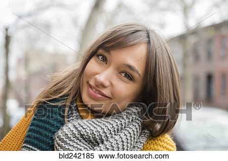 Portrait of smiling Mixed Race woman wearing scarf in city View Large Photo Image Stock Photography - Portrait of smiling Mixed Race woman wearing scarf in city. Fotosearch