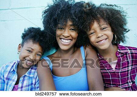 Stock Photo - Portrait of smiling mother and daughters. Fotosearch