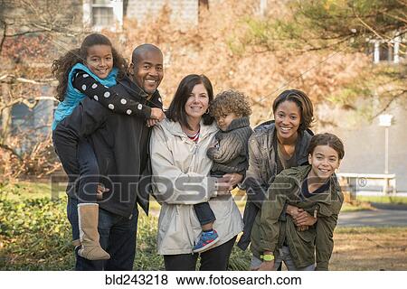 Stock Photo - Portrait of smiling multi-ethnic family. Fotosearch