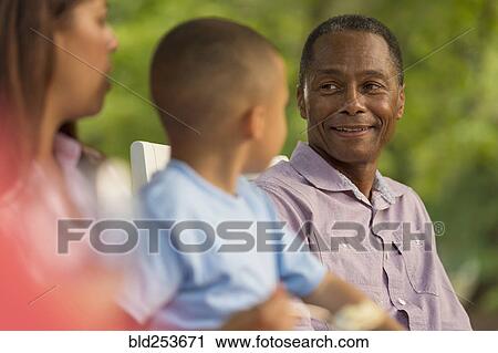 Stock Image - Portrait of smiling multi-generation family. Fotosearch