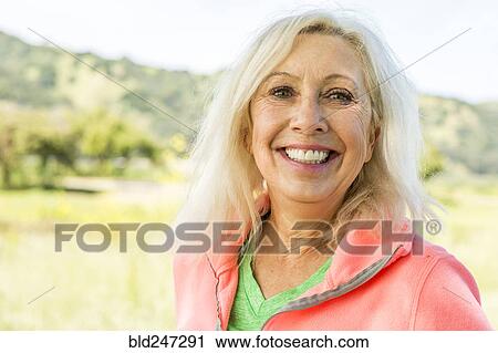 Portrait of smiling Older Caucasian woman outdoors View Large Photo Image Stock Image - Portrait of smiling Older Caucasian woman outdoors. Fotosearch