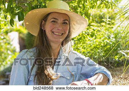 Stock Photo - Portrait of smiling older Caucasian woman in garden. Fotosearch