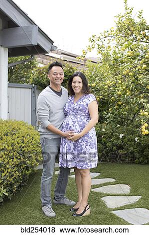 Stock Photo - Portrait of smiling pregnant couple. Fotosearch
