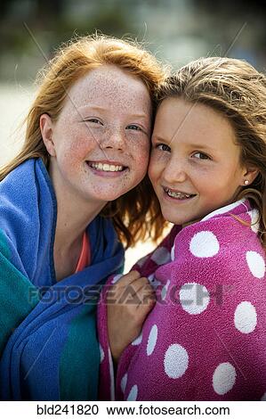 Portrait of smiling sisters wrapped in towels View Large Photo Image Stock Image - Portrait of smiling sisters wrapped in towels. Fotosearch
