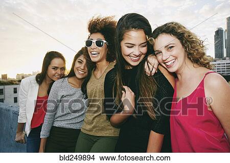 Picture - Portrait of smiling women on urban rooftop. Fotosearch